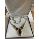 A SILVER ABSTRACT DESIGN NECKLACE WITH AMBER COLOURED STONES IN A PRESENTATION BOX