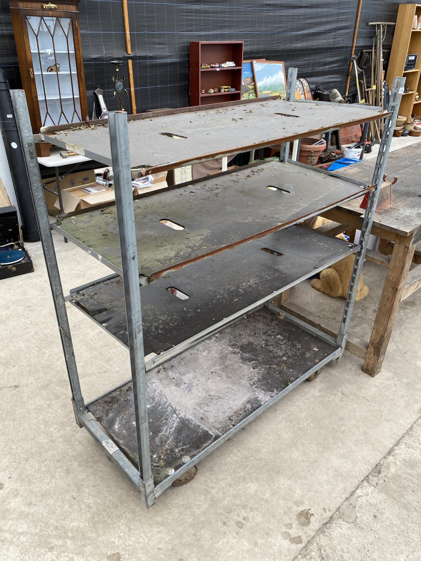 A FOUR WHEELED DUTCH TROLLEY WITH THREE ADDITIONAL SHELVES