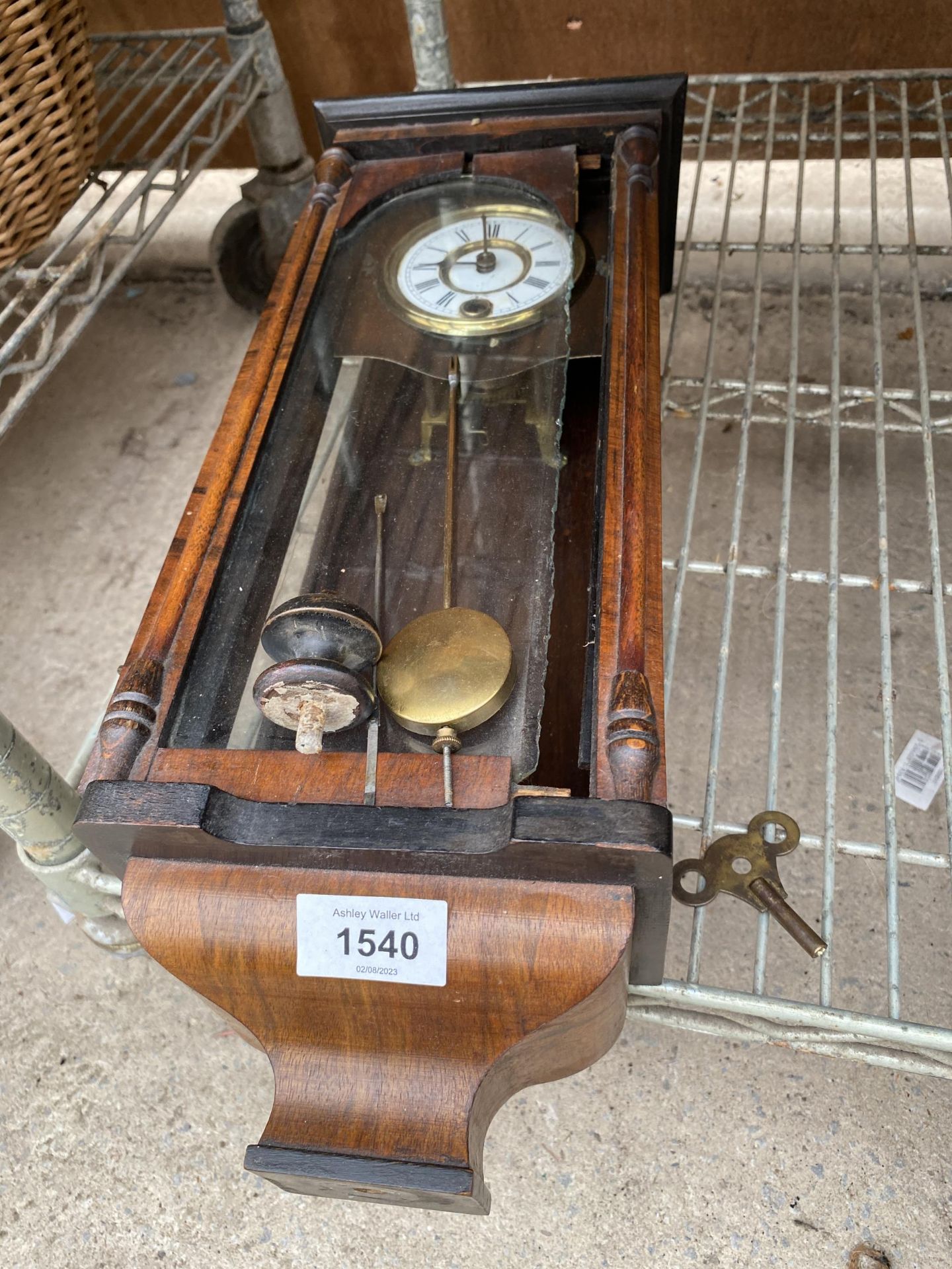 A VINTAGE MAHOGANY WALL CLOCK COMPLETE WITH KEY