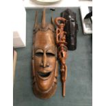 TWO AFRICAN STYLE FACE MASKS PLUS A TRIBAL STYLE CARVED STICK WITH SERPENT DESIGN