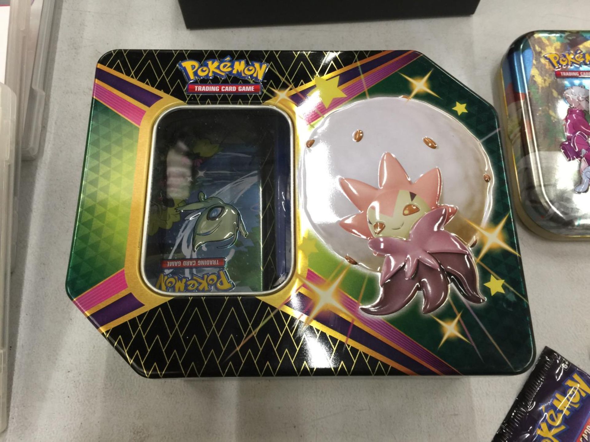 A COLLECTORS TIN OF POKEMON CARDS INCLUDING SHINIES, ETC - 100+