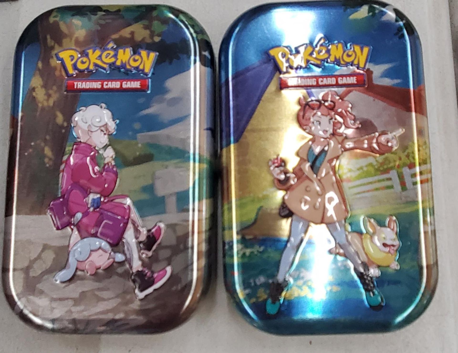 TWO TINS OF POKEMON CARDS TO INCLUDE SHINIES, ETC - 100+