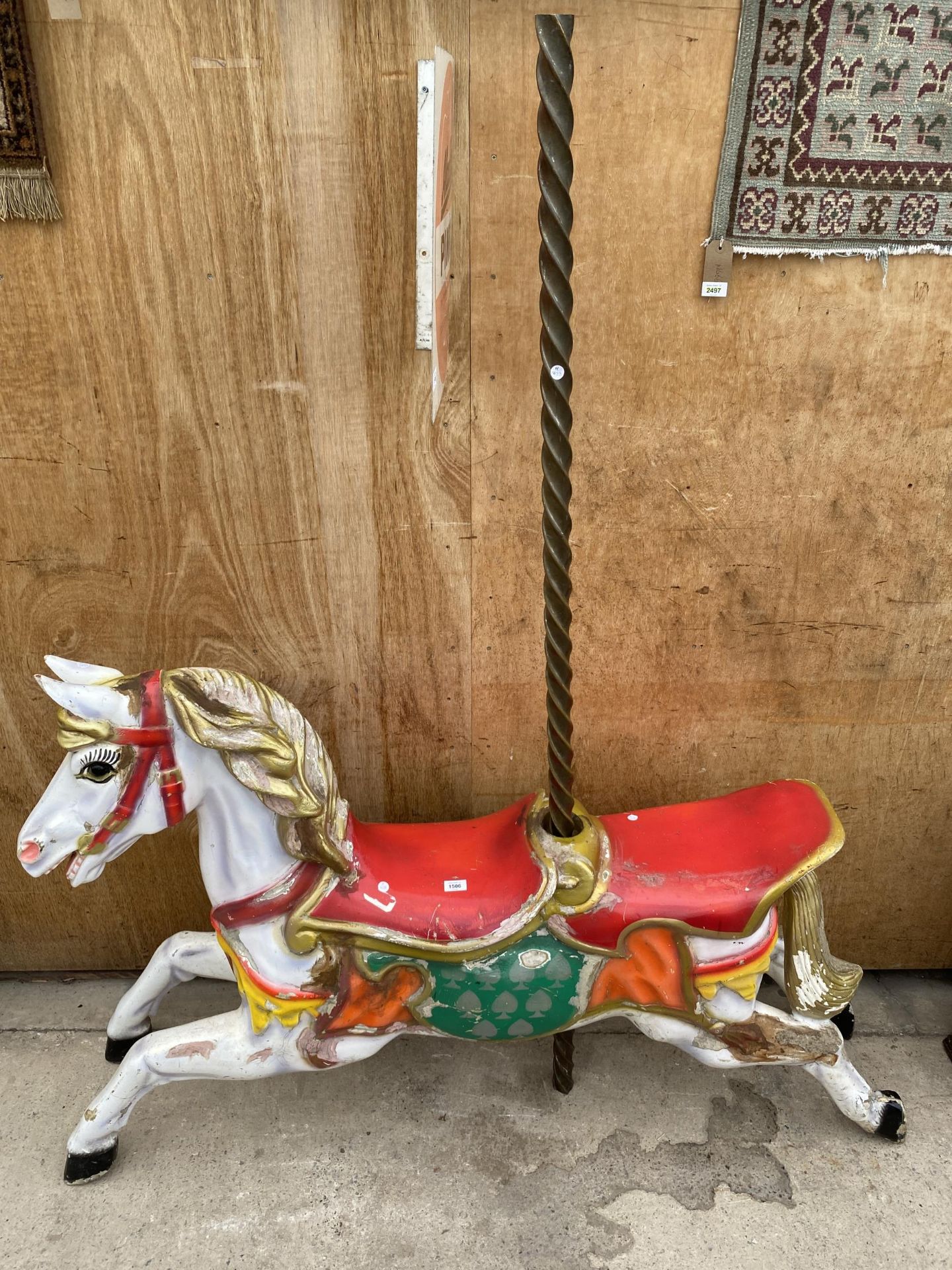 A BELIEVED ORIGINAL EX FAIRGROUND RIDE GALLOPER WITH DOUBLE SEAT AND TURNED BRASS POLE