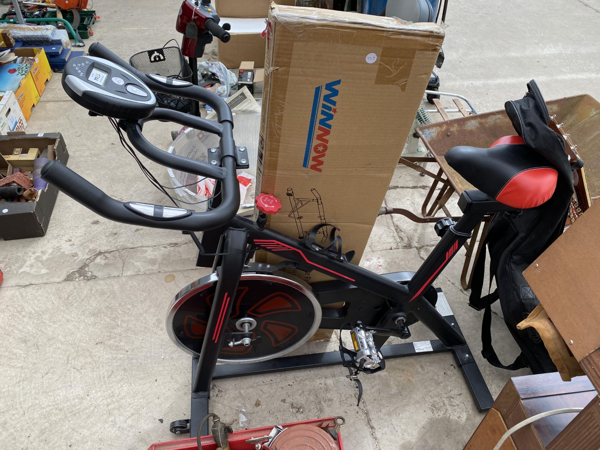 AN EXERCISE BIKE AND A DOOR FRAME PULL UP BAR
