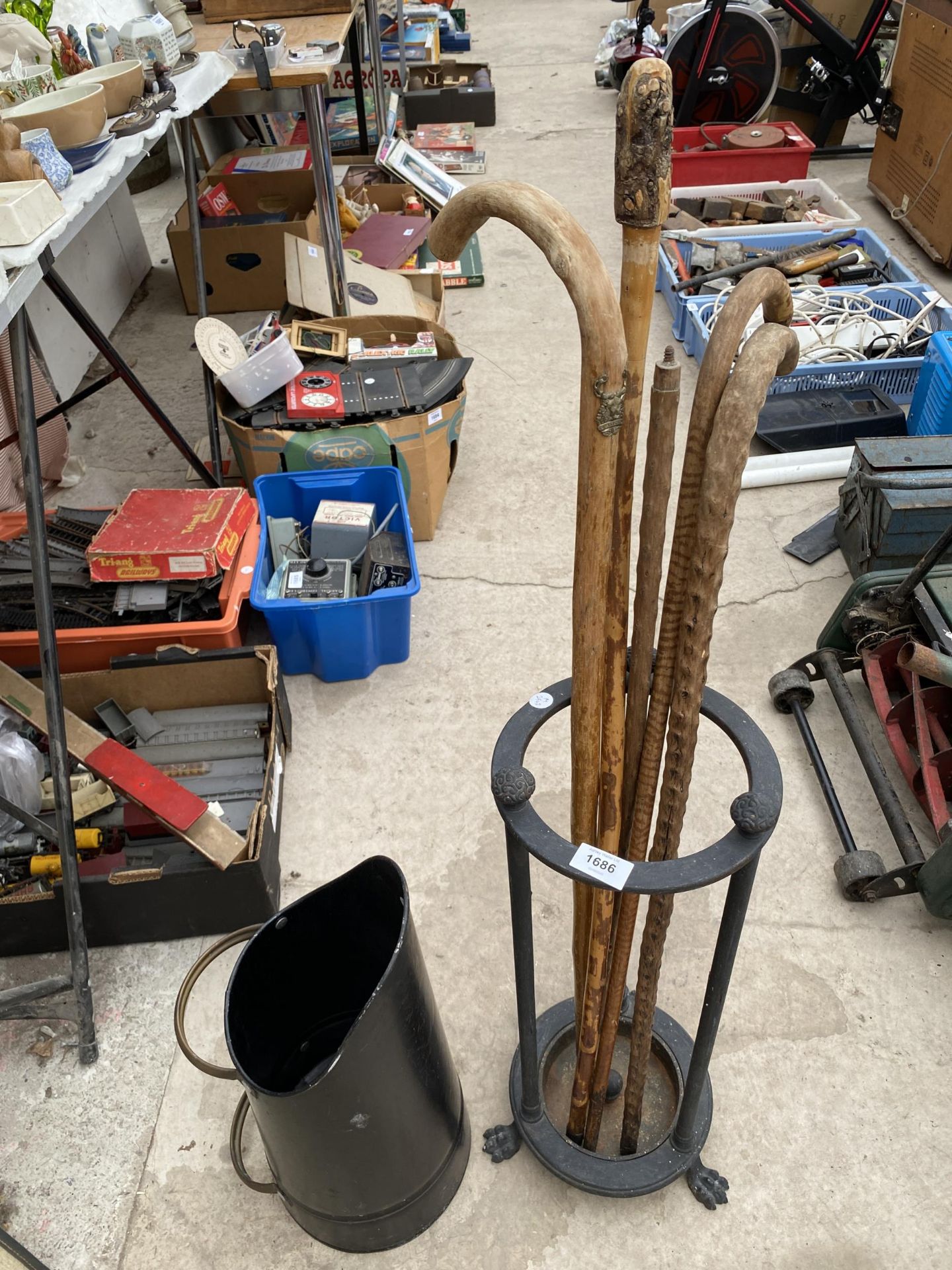 A VINTAGE STICK STAND WITH LION PAW FEET, AN ASSORTMENT OF WALKING STICKS AND A COAL SKUTTLE ETC