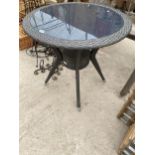 A RATTAN GLASS TOPPED BISTRO TABLE