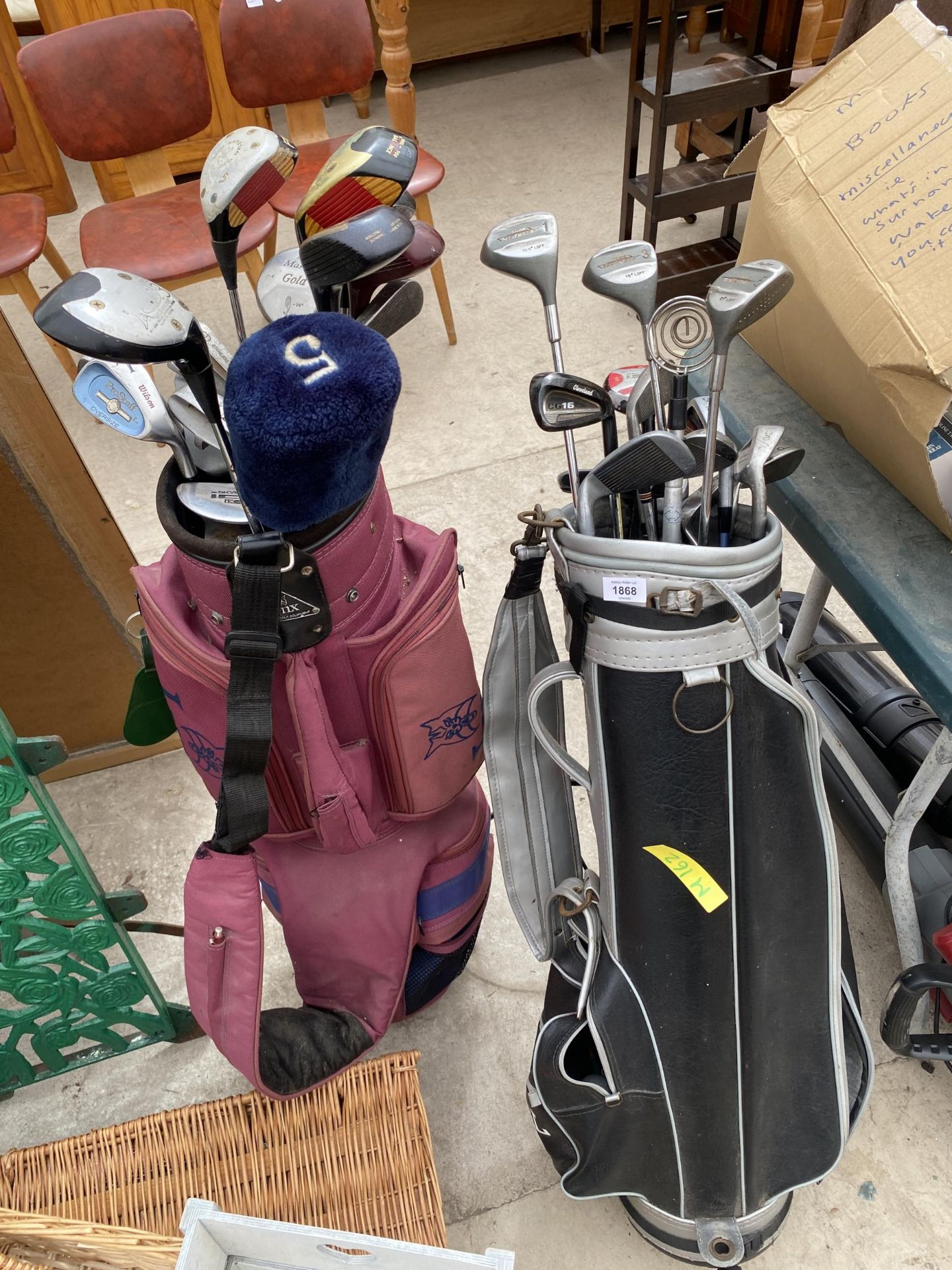 TWO GOLF BAGS AND AN ASSORTMENT OF GOLF CLUBS