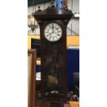 AN EDWARDIAN DOUBLE WEIGHTED CHIMING WALL CLOCK IN MAHOGANY CASE, WITH WEIGHTS