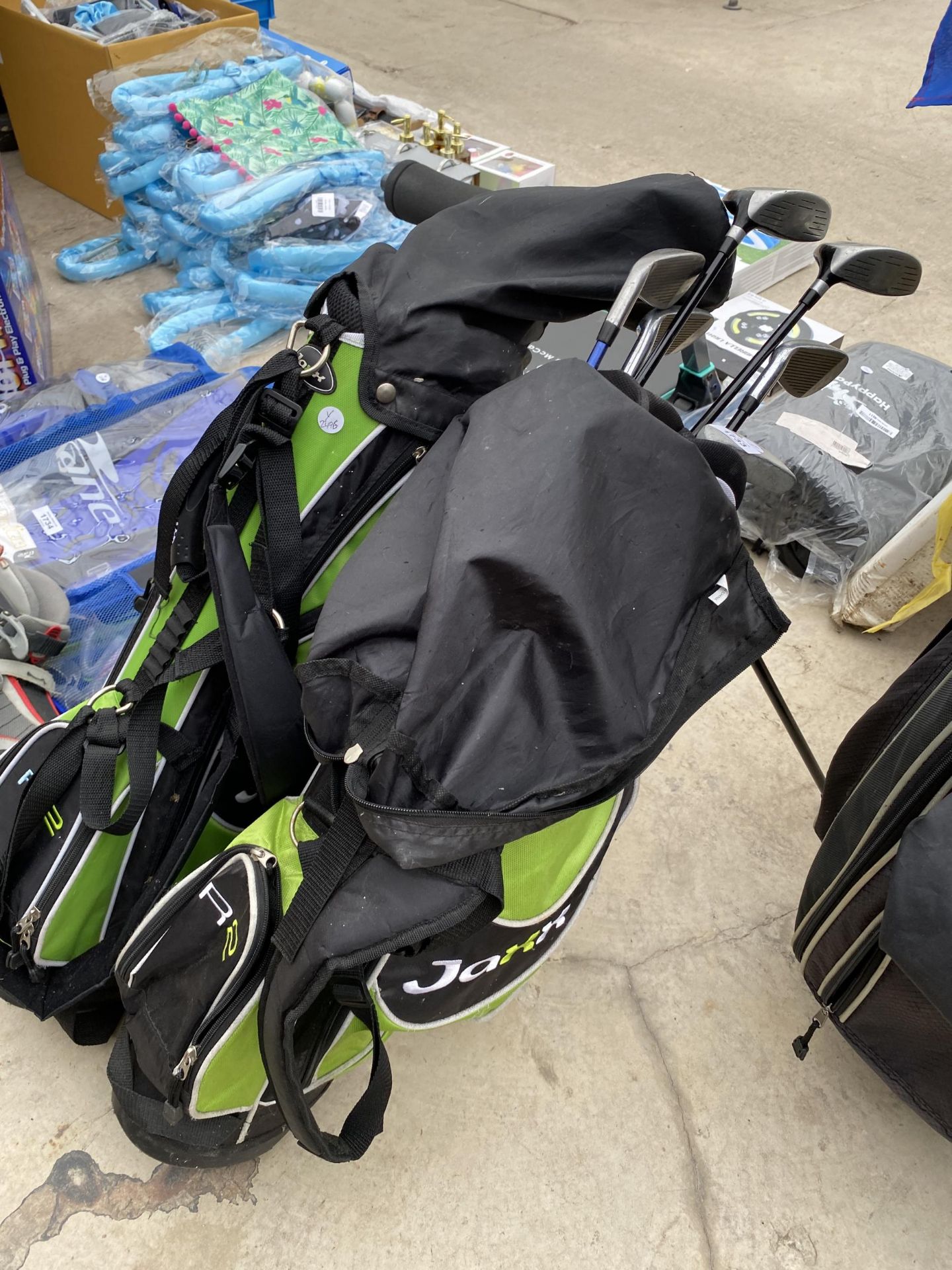 TWO CHILDRENS GOLF BAGS AND AN ASSORTMENT OF CHILDRENS GOLF CLUBS