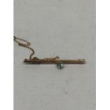 A BLUE STONE 9CT GOLD PIN