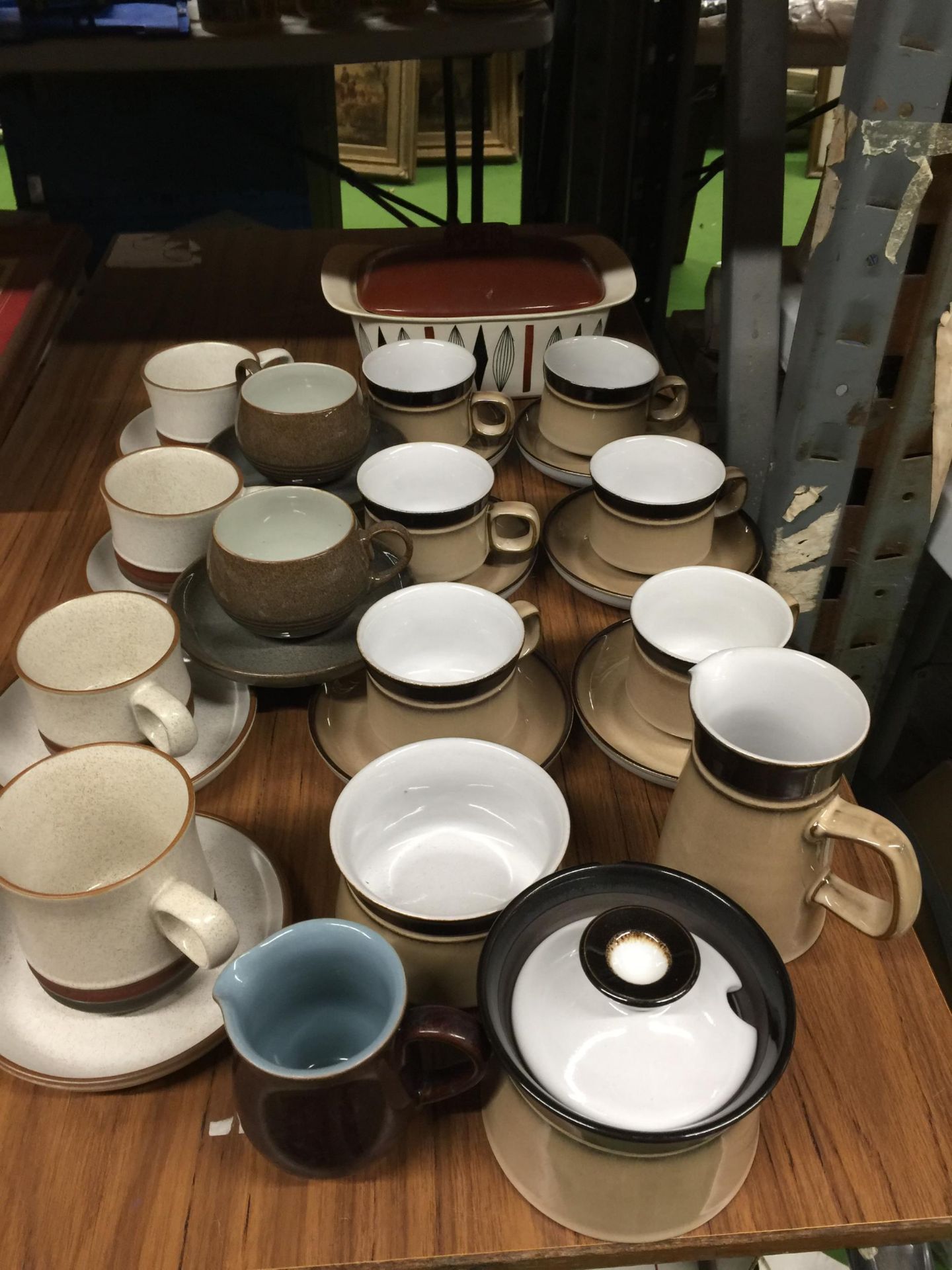 A GROUP OF DENBY STONEWARE CUPS AND SAUCERS