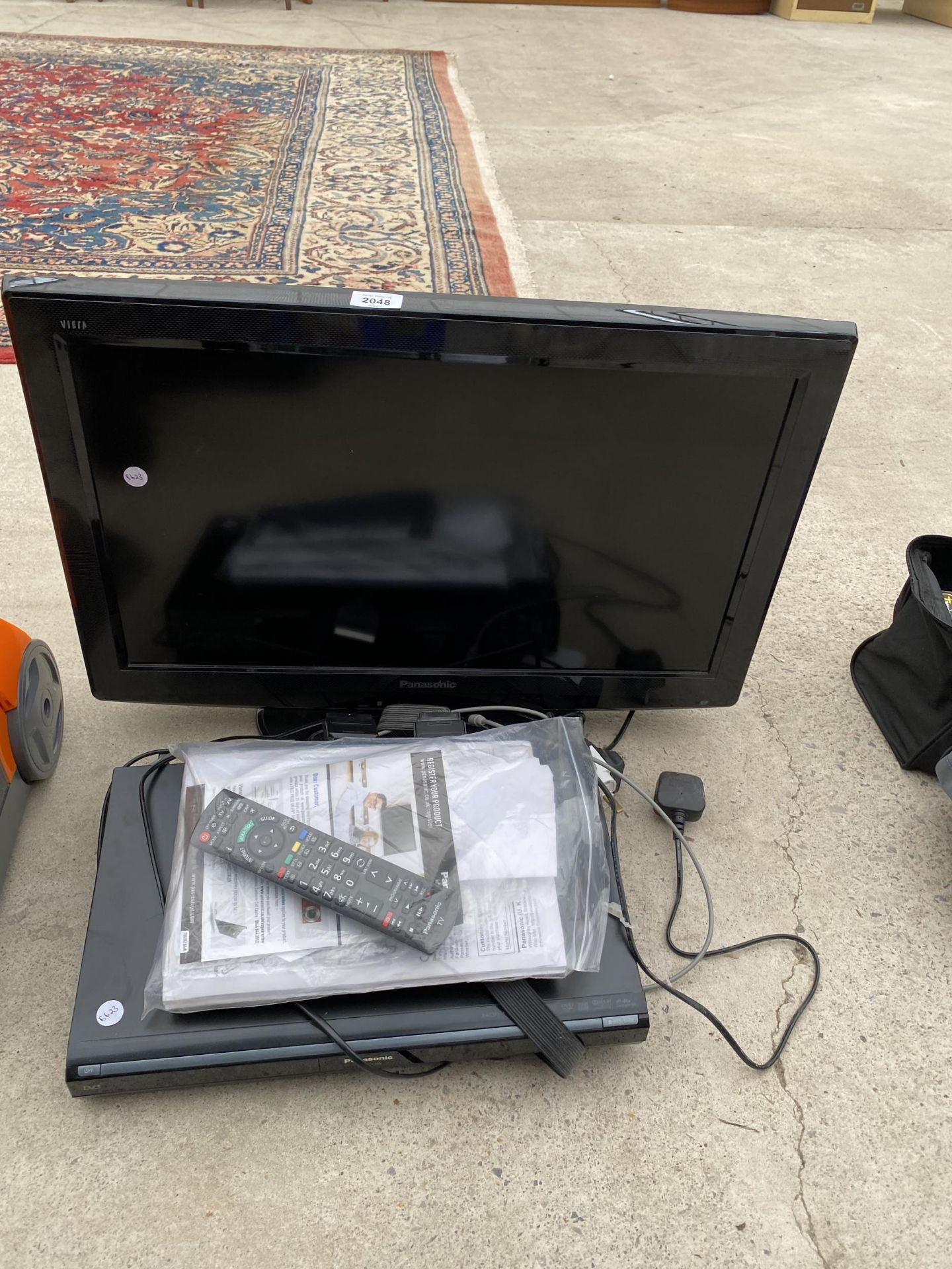 A PANASONIC 26" TELEVISION AND A PANASONIC DVD PLAYER COMPLETE WITH REMOTE CONTROL