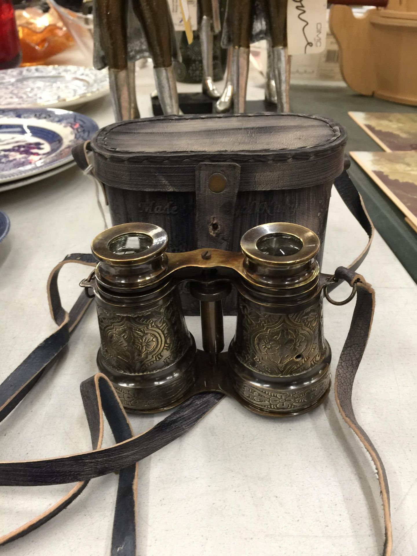 A PAIR OF LEATHER CASED BRASS BINOCULARS