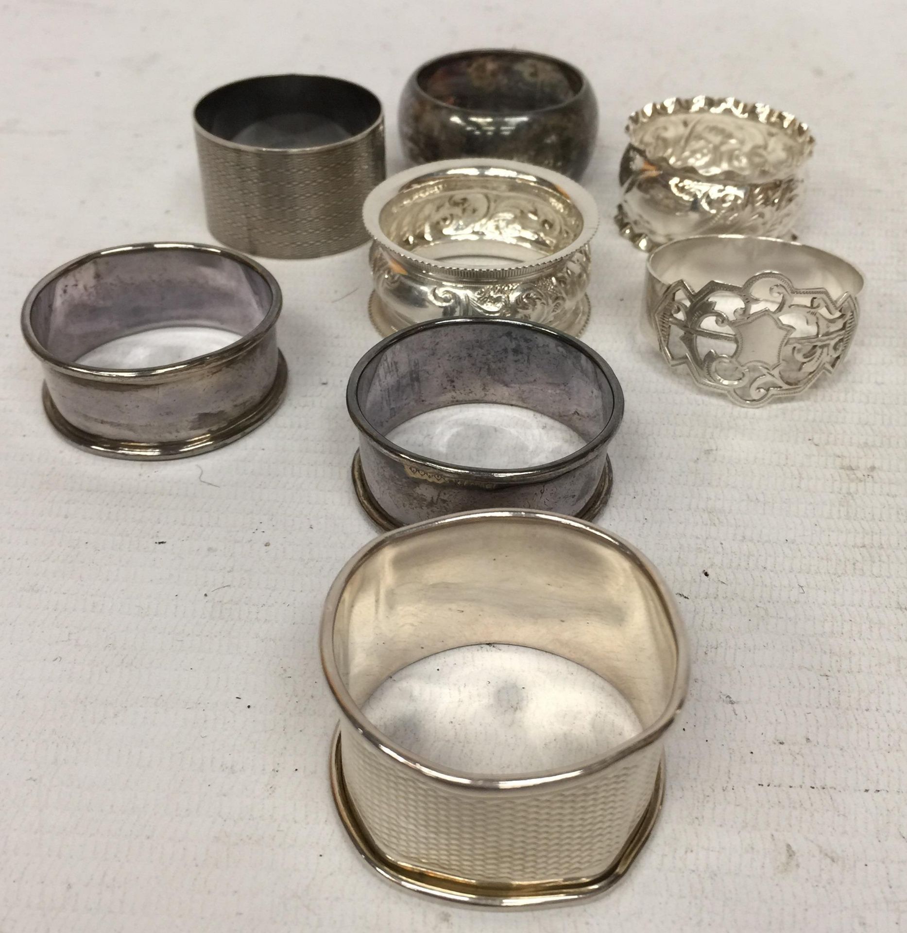 A COLLECTION OF EIGHT ASSORTED HALLMARKED SILVER NAPKIN RINGS