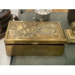 A VINTAGE BRASS BOX WITH AN EMBOSSED IMAGE OF WILD BOARS TO THE LID