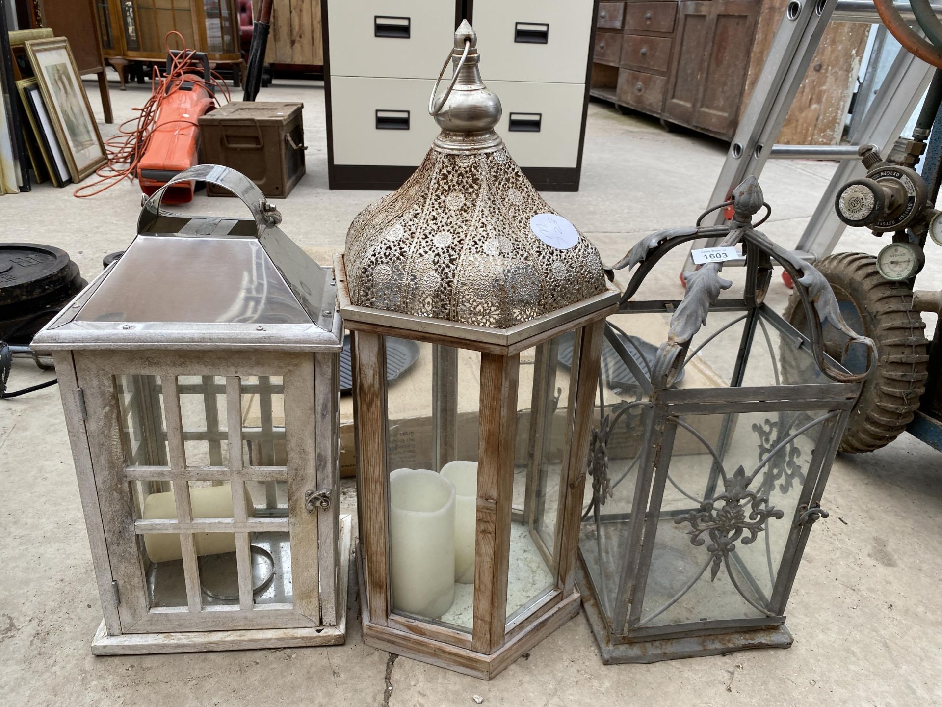 THREE VARIOUS GLASS AND METAL CANDLE LANTERNS