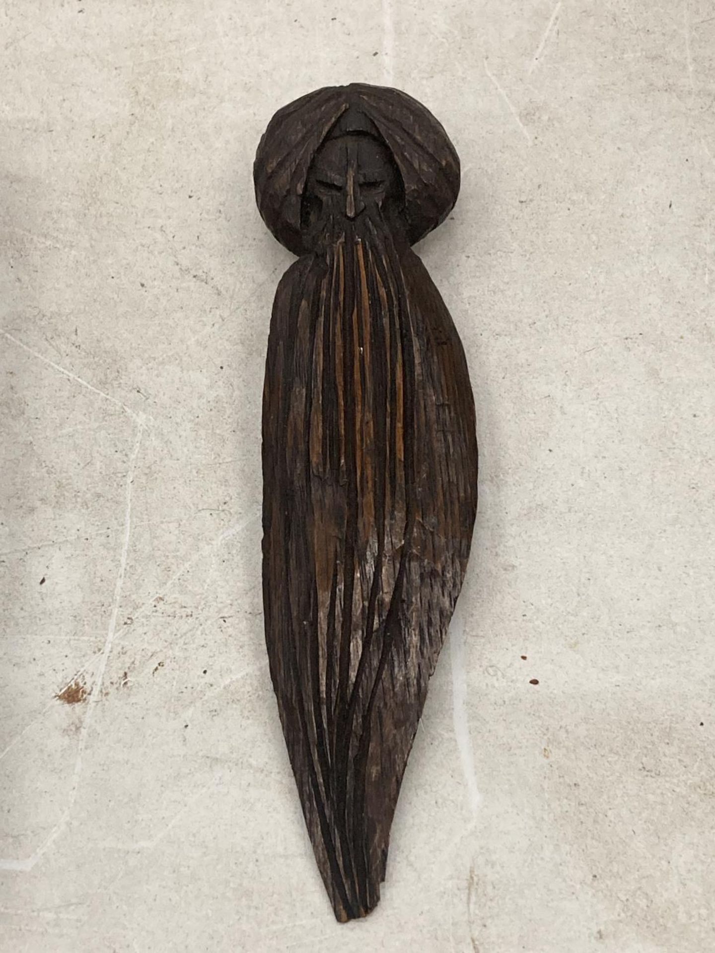 A VINTAGE CARVED WOODEN LETTER OPENER IN THE GUISE OF A HOLY MAN