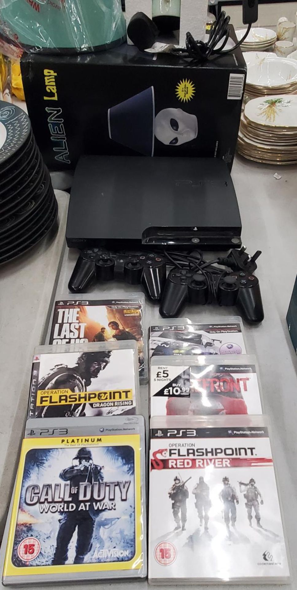 A PS3 GAMES CONSOLE WITH 2 CONTROLLERS AND SIX GAMES TO INCLUDE GRAN TURISMO 5 CALL OF DUTY,