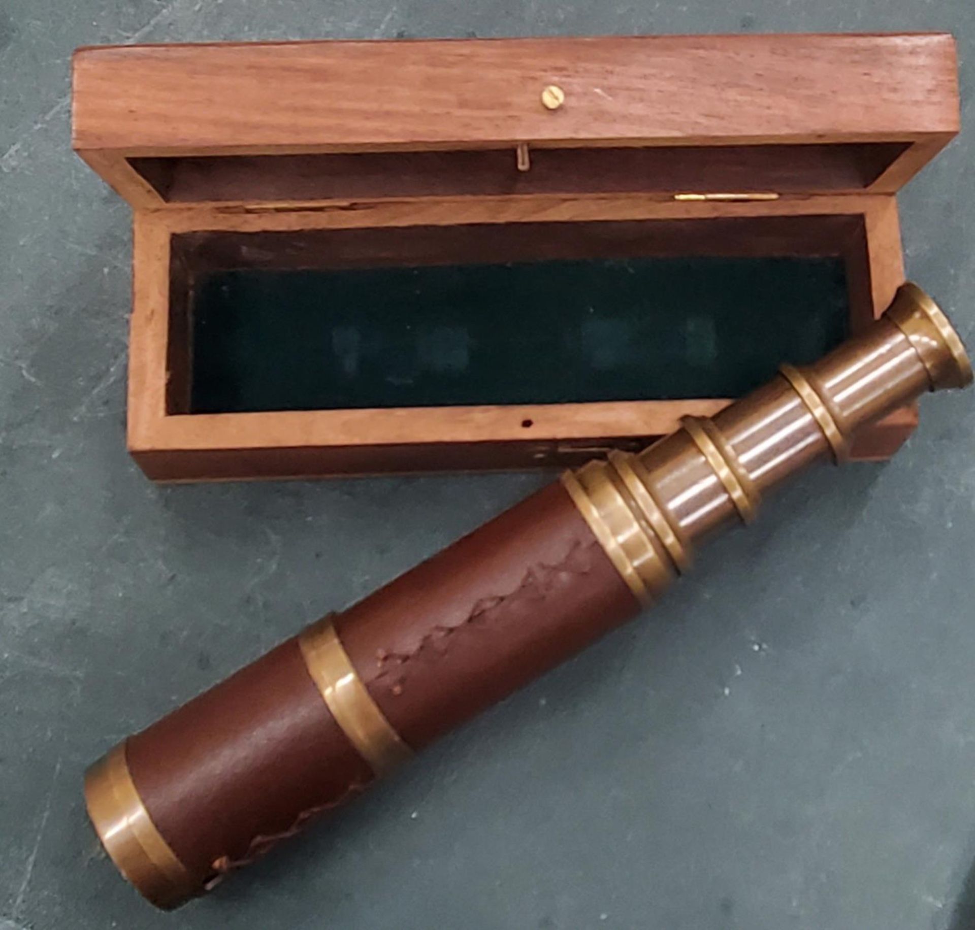 A BOXED BRASS AND LEATHER TELESCOPE