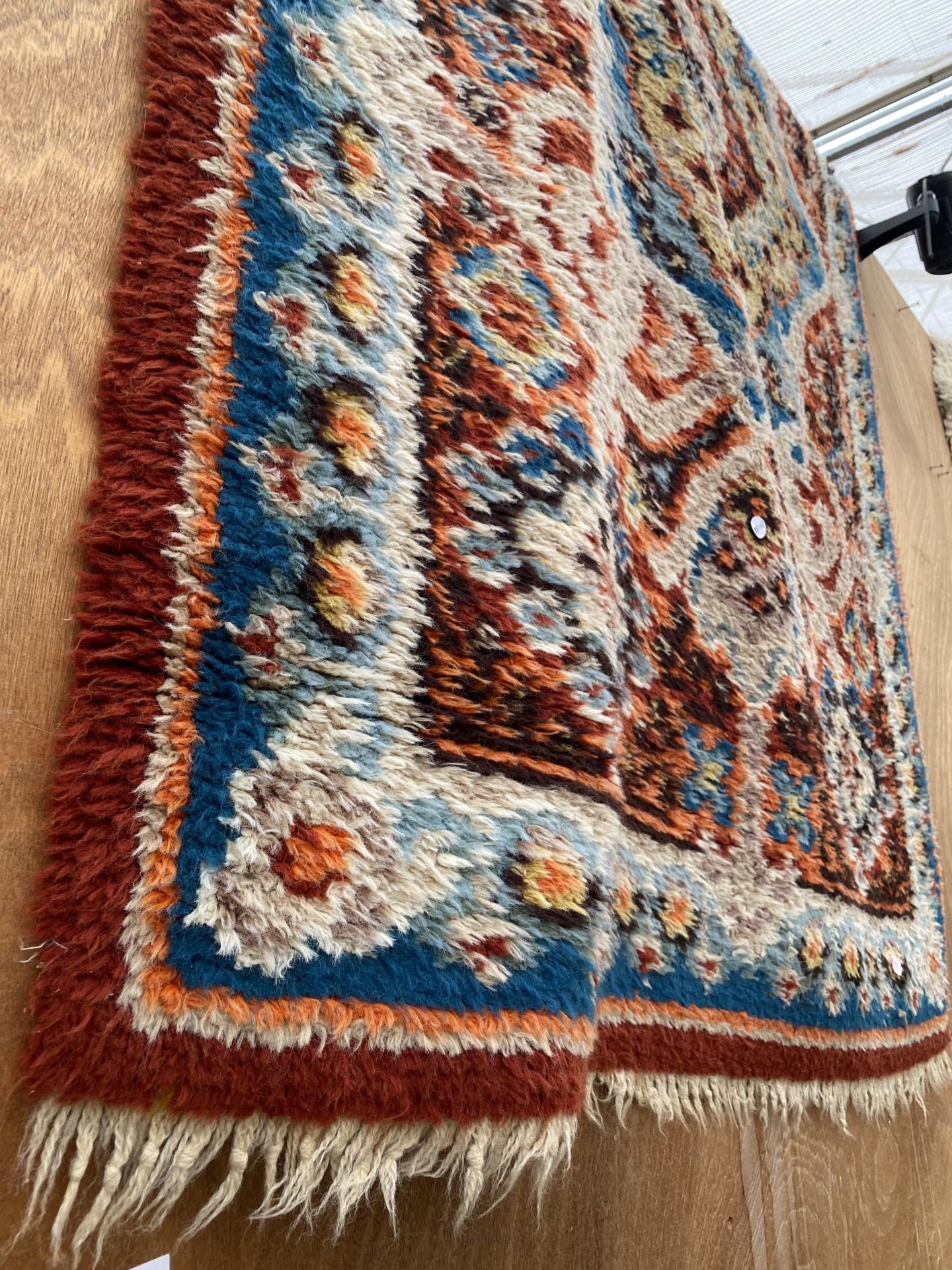 A MULTI COULOURED PATTERNED FRINGED RUG - Image 2 of 2