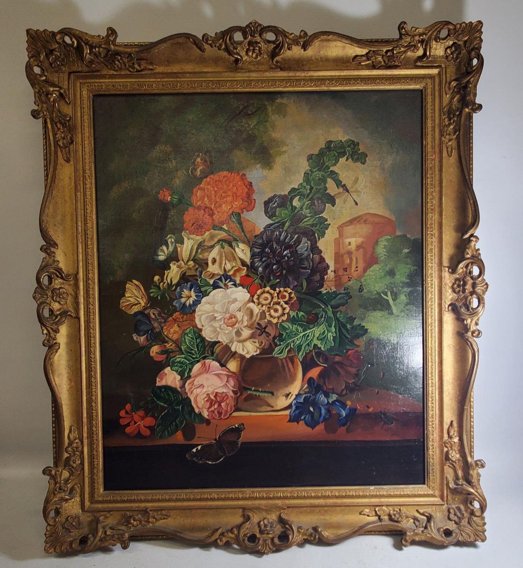 A 20TH CENTURY OIL ON CANVAS DEPICTING A VASE OF FLOWERS IN A CASTLE LANDSCAPE, 60X49CM, IN SWEPT