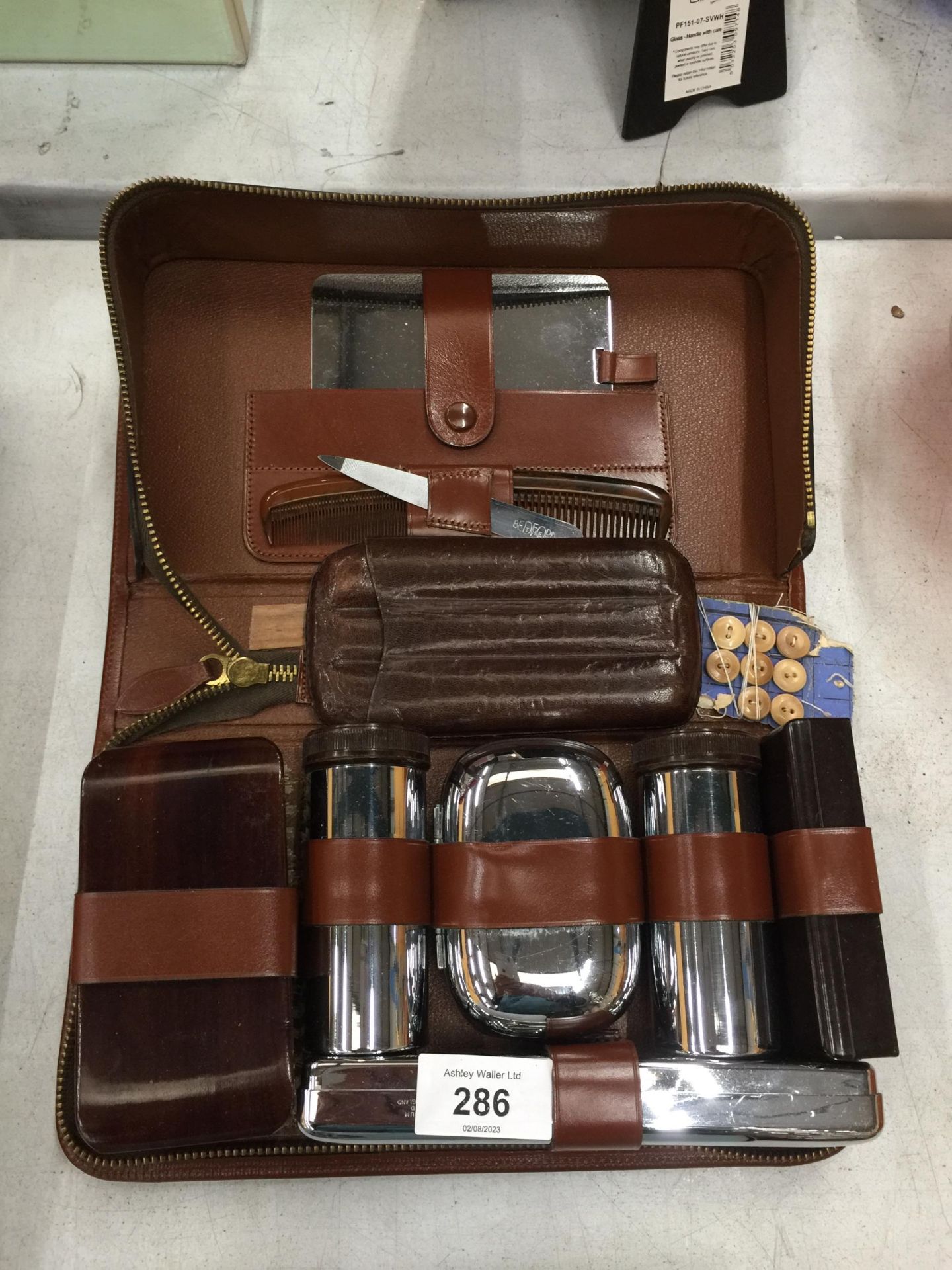 A GENTLEMEN'S GROOMING KIT IN A LEATHER CASE