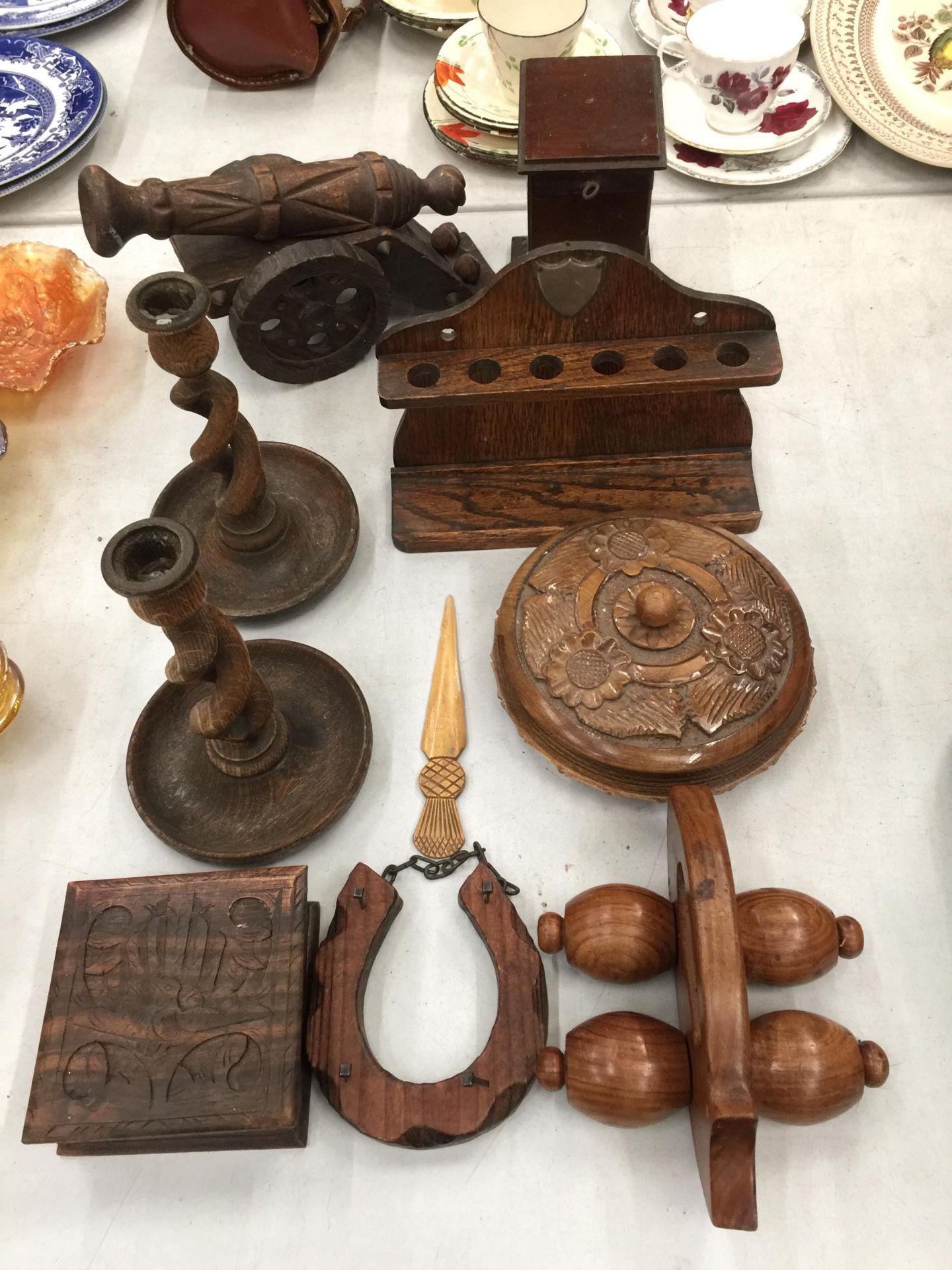 A COLLECTION OF TREEN TO INCLUDE CANDLESTICKS WITH TWISTED STEMS, A PIPE RACK, CANON, BOXES, PAGE