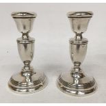 A PAIR OF HALLMARKED SILVER CANDLESTICKS, (WEIGHTED BASES)