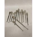 A COLLECTION OF THIRTEEN VICTORIAN AND LATER SILVER HANDLED BUTTON HOOKS
