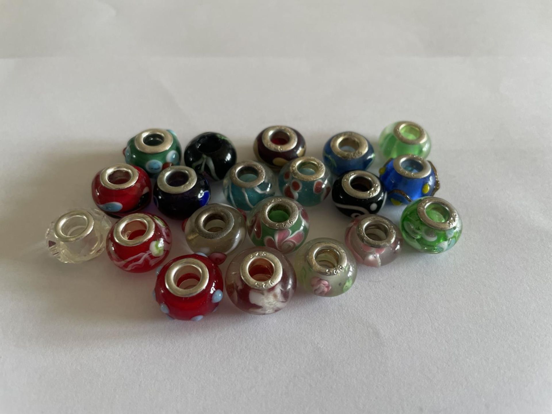 TWENTY SILVER RIMMED MURANO GLASS BEADS