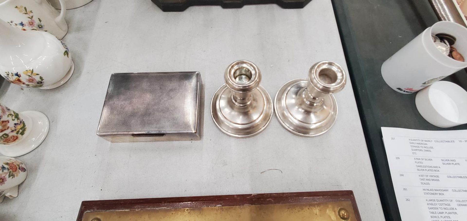 A PAIR OF SILVER PLATED CANDLESTICKS AND A SILVER PLATED BOX