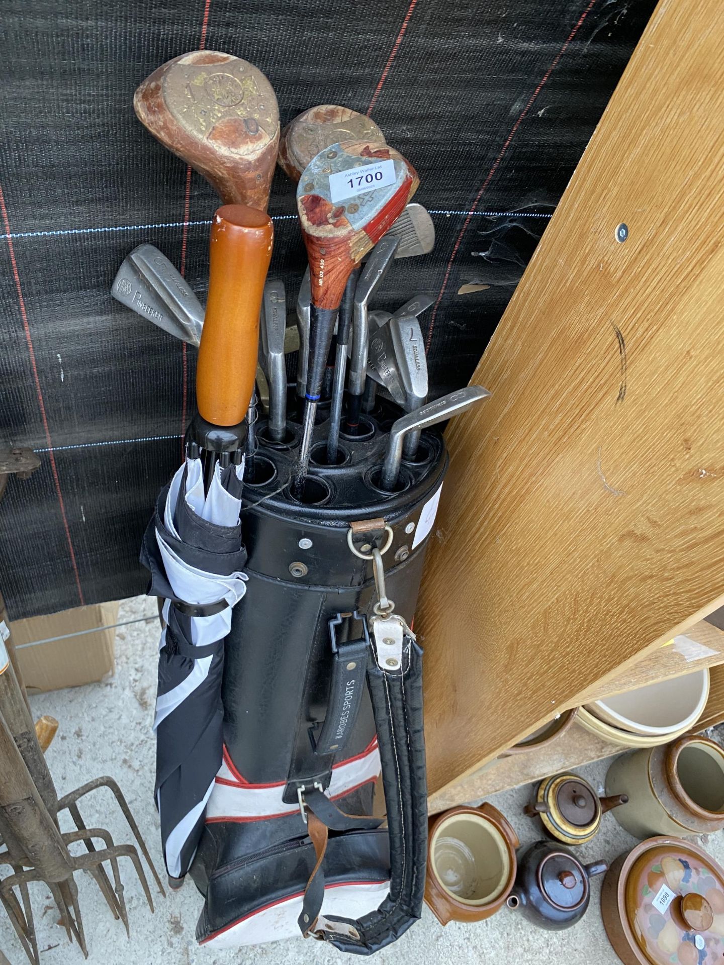 A GOLF BAG AND AN ASSORTMENT OF RETRO GOLF CLUBS