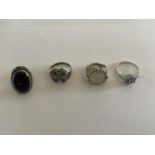 FOUR VARIOUS SILVER RINGS