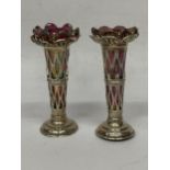 A PAIR OF CHESTER HALLMARKED SILVER BUD VASES WITH PINK LUSTRE EFFECT GLASS LINERS