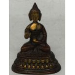 AN ORIENTAL BRONZE MODEL OF A SEATED BUDDHA