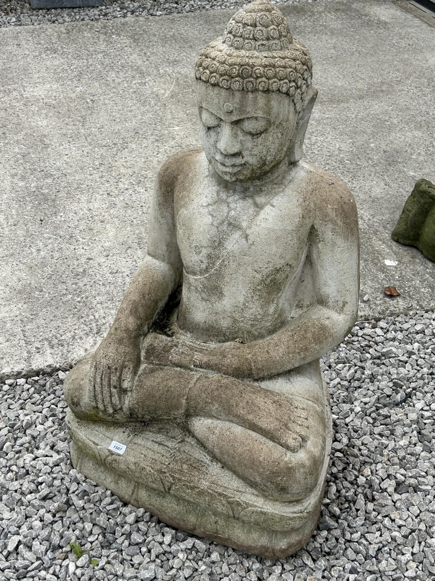 A LARGE RECONSTITUTED STONE BUDDHIST DIETY FIGURE - HEIGHT 107 CM, DEPTH 48 CM