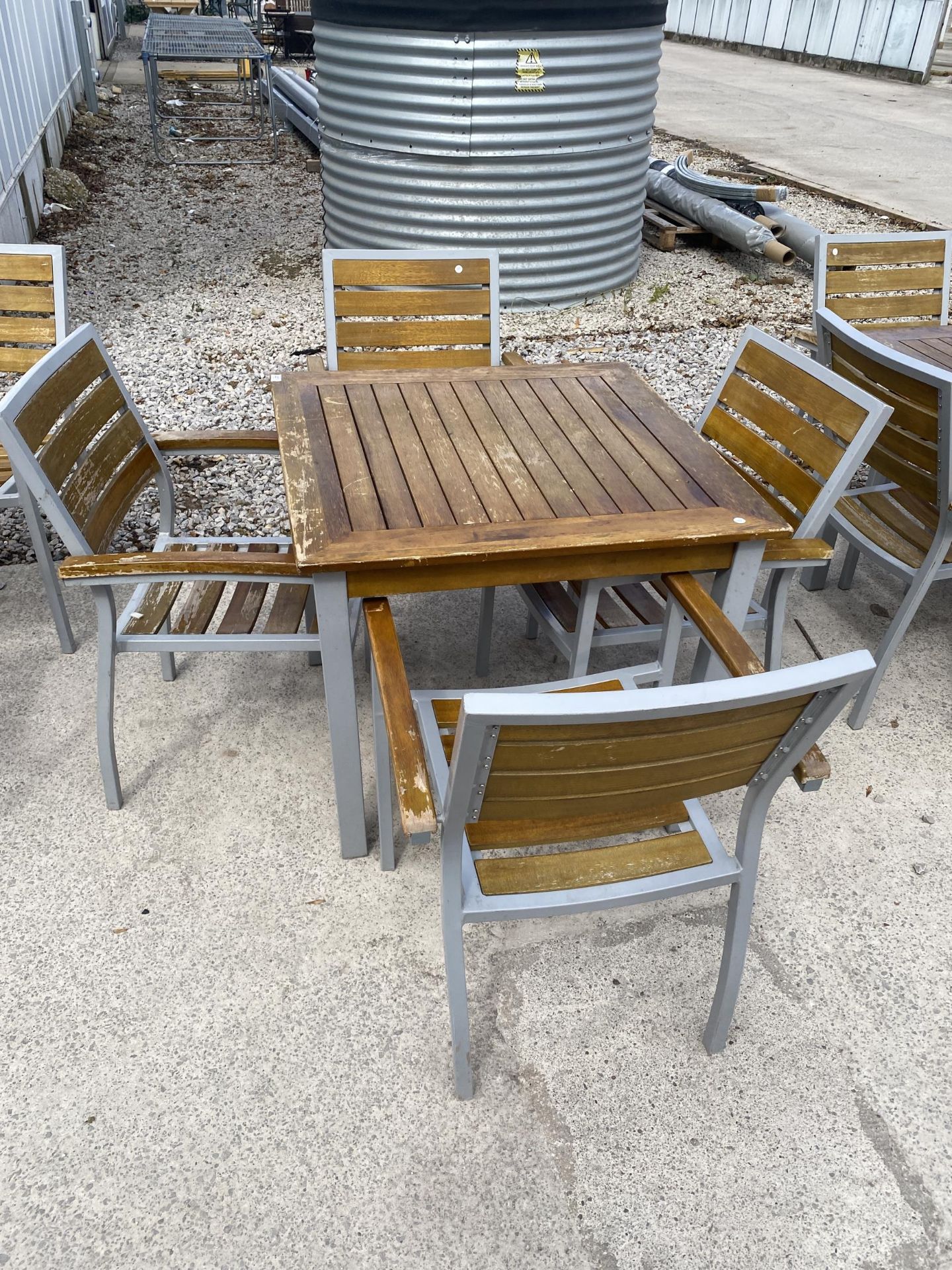 A GARDEN TABLE AND FOUR CHAIRS