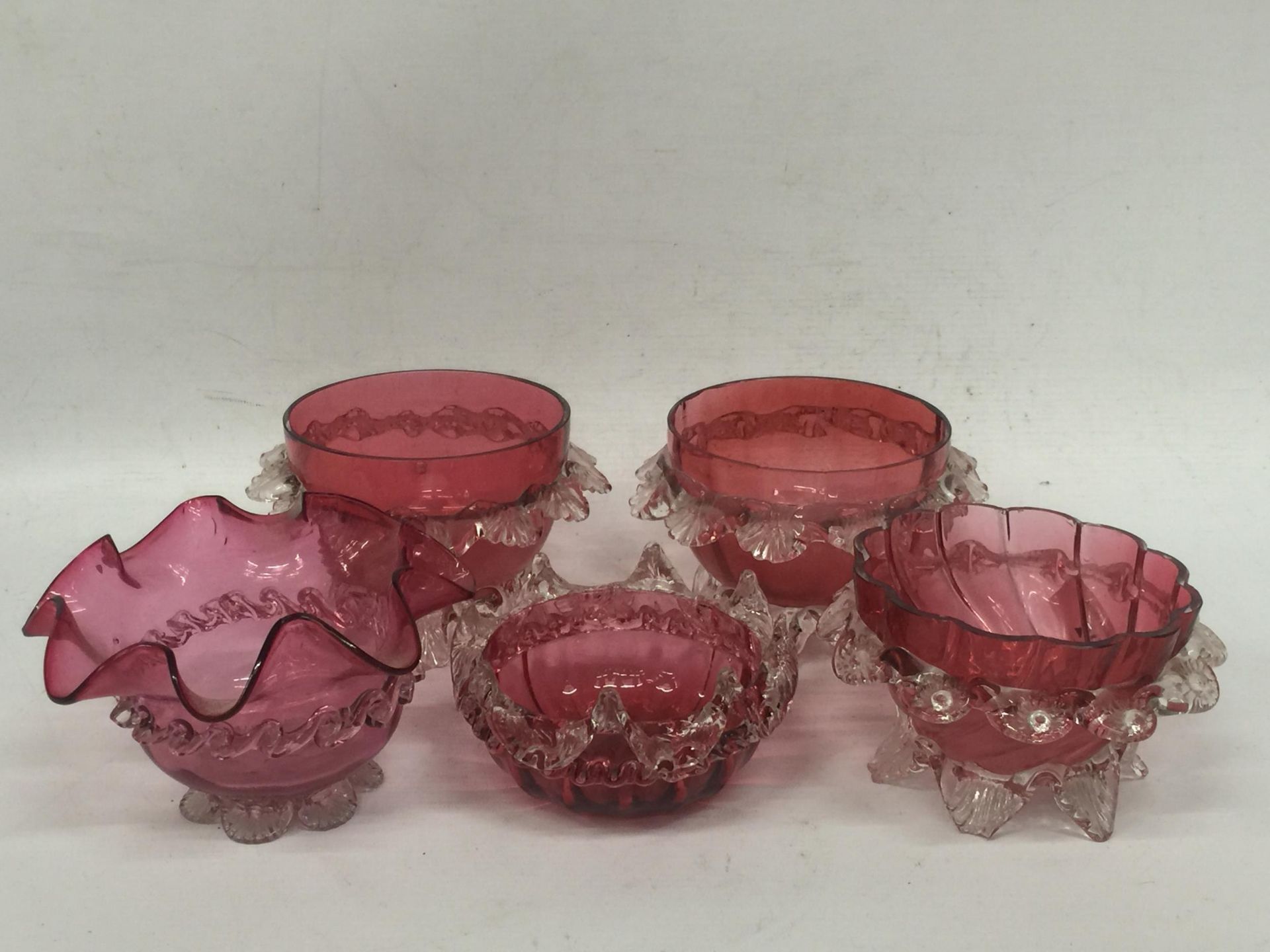 A GROUP OF FIVE VINTAGE CRANBERRY GLASS BOWLS