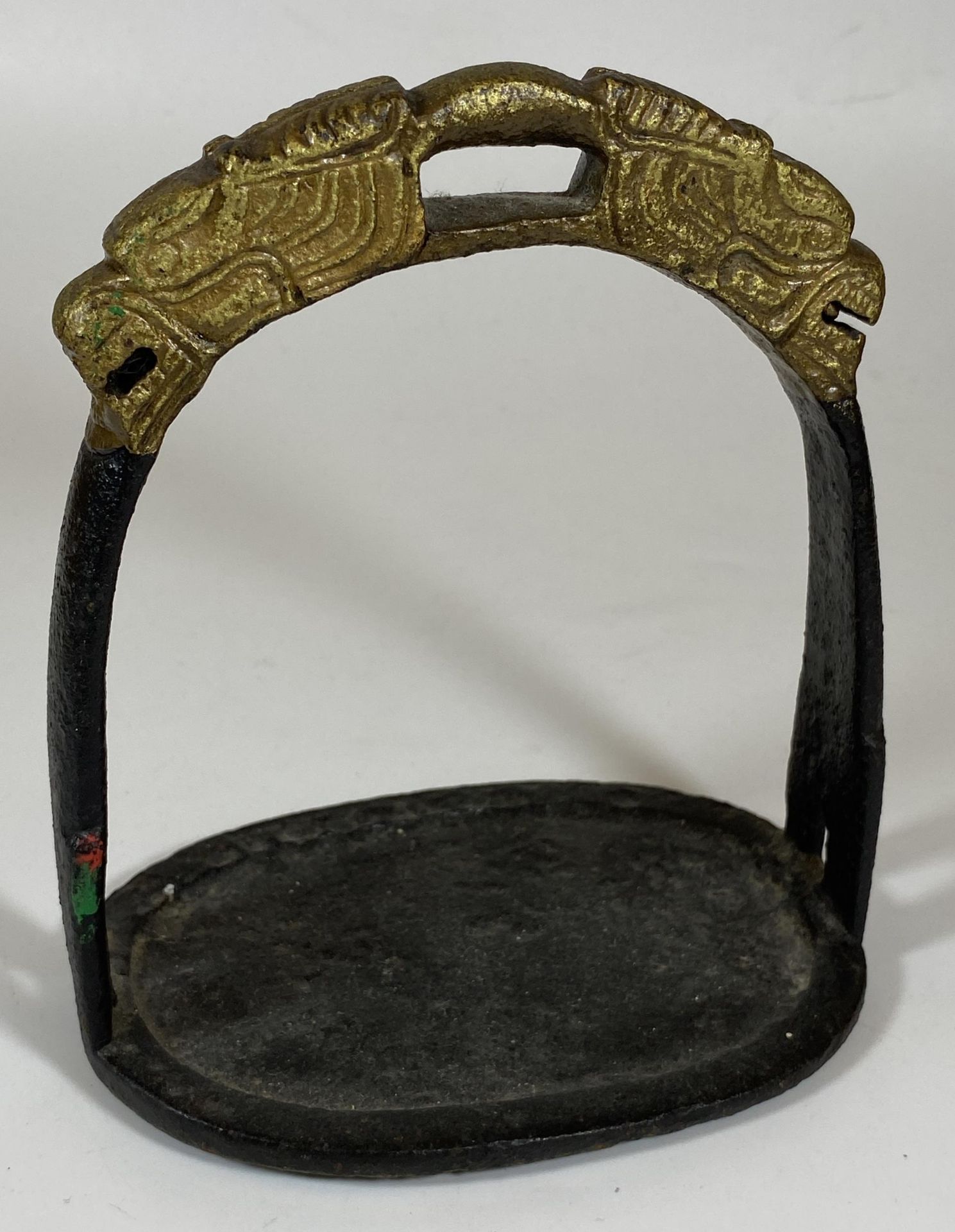A SOLID CAST IRON ORIENTAL STIRRUP WITH DRAGON HEAD DESIGN, HEIGHT 15CM