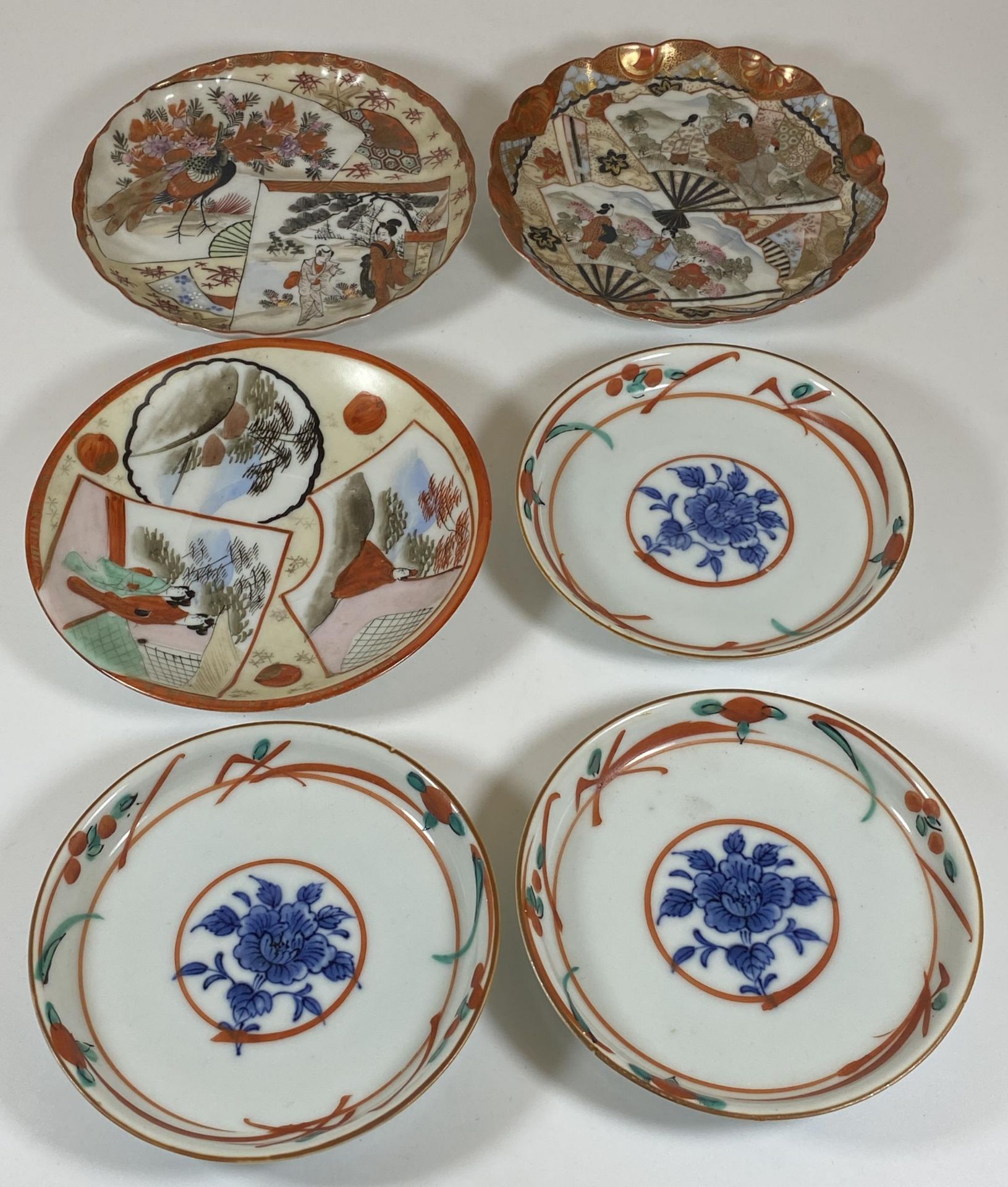 SIX JAPANESE PORCELAIN DISHES - SET OF THREE FLORAL EXAMPLES AND THREE KUTANI EXAMPLES, LARGEST