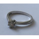 AN 18 CARAT WHITE GOLD DIAMOND SOLITAIRE RING WITH A 0.33 CARAT DIAMOND WITH A 'VERY GOOD' QUALITY E