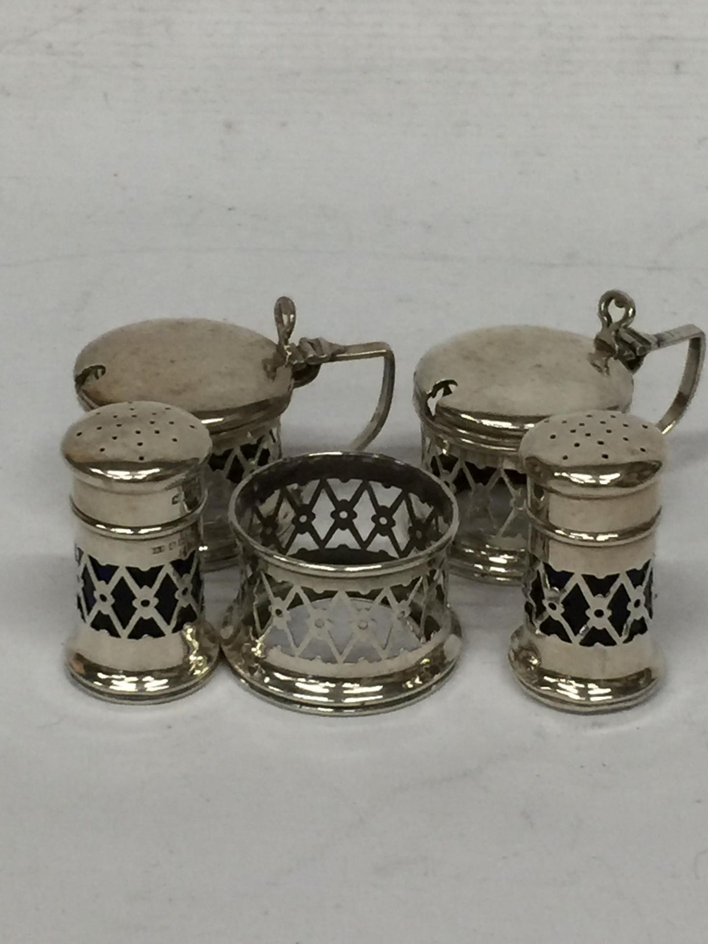 A SET OF FIVE HALLMARKED SILVER CONDIMENT ITEMS - LIDDED POTS, OPEN SALT AND SHAKERS