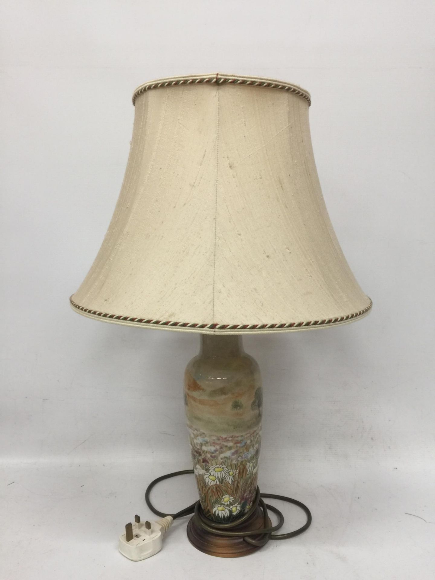 A COBRIDGE STONEWARE DAISY FIELD PATTERN TABLE LAMP AND SILK SHADE