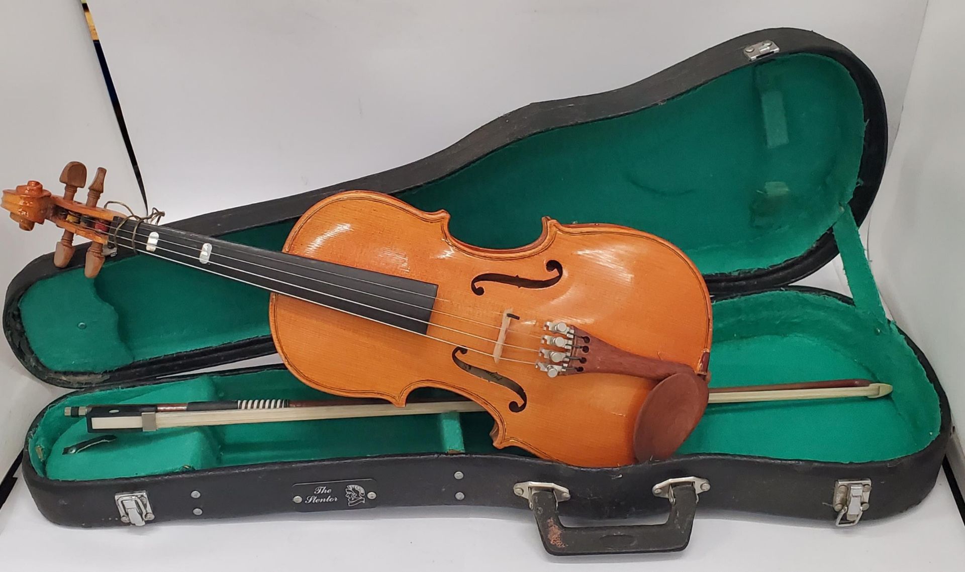 A CHILD'S WOODEN VIOILIN AND BOW IN A CASE