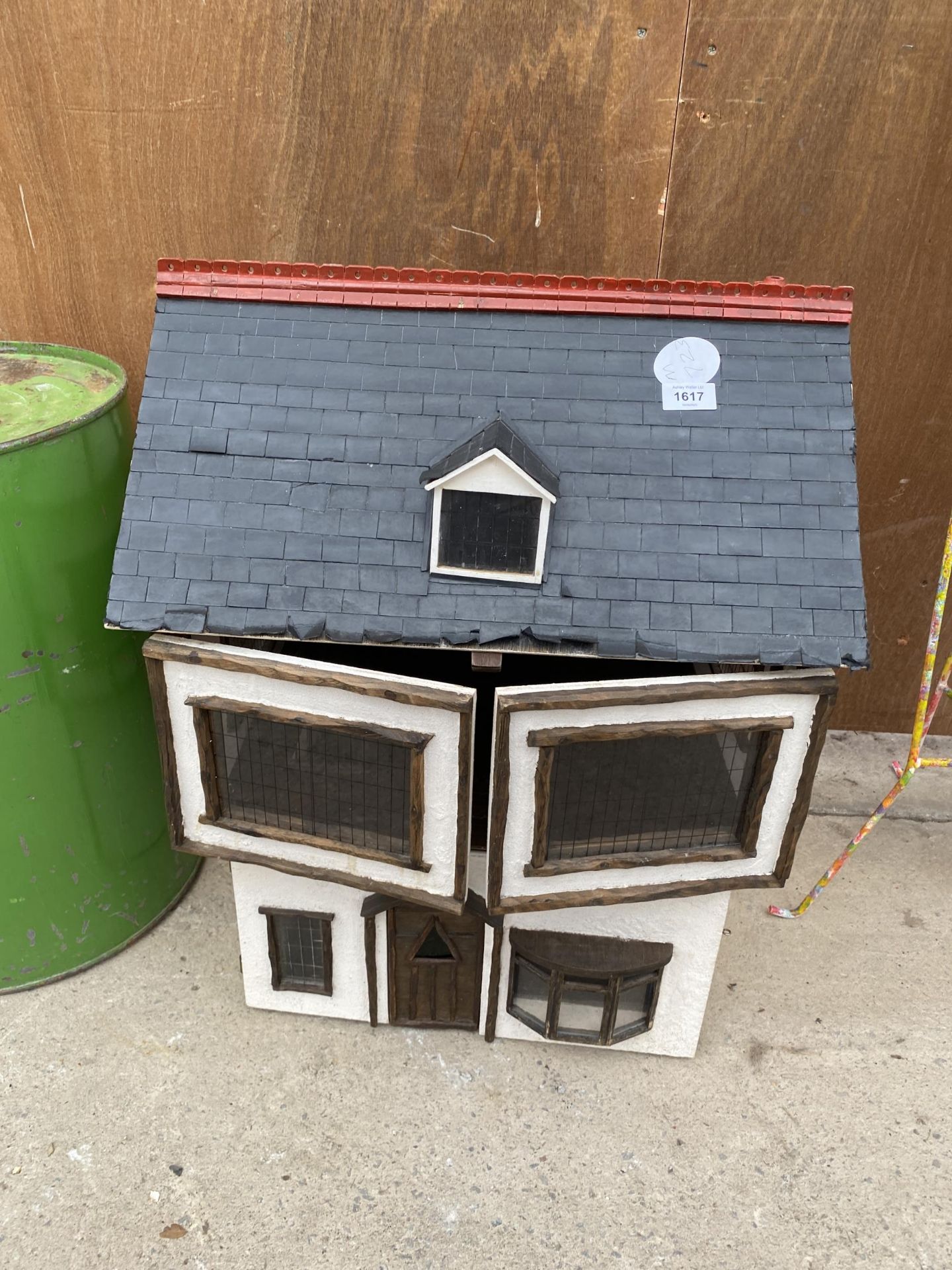 A VINTAGE WOODEN DOLLS HOUSE