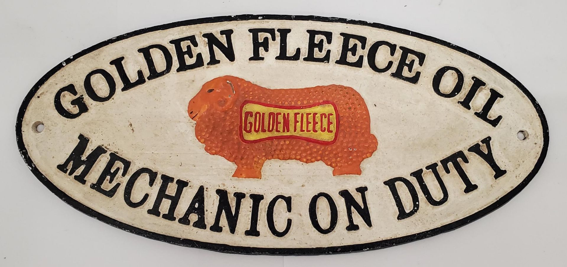 A CAST METAL SIGN GOLDEN FLEECE OIL MECHANIC ON DUTY