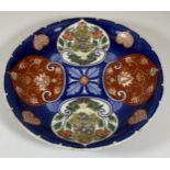 A JAPANESE MEIJI PERIOD (1868-1912) IMARI ON BLUE GROUND FLORAL PATTERN DISH, SIX CHARACTER MARK