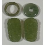 A GROUP OF FOUR CHINESE JADEITE JADE STYLE ITEMS - TWO CARVED PENDANT PLAQUES AND TWO RINGS