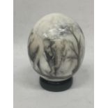 A HANDPAINTED OSTRICH EGG WITH ELEPHANT DESIGN ON STAND