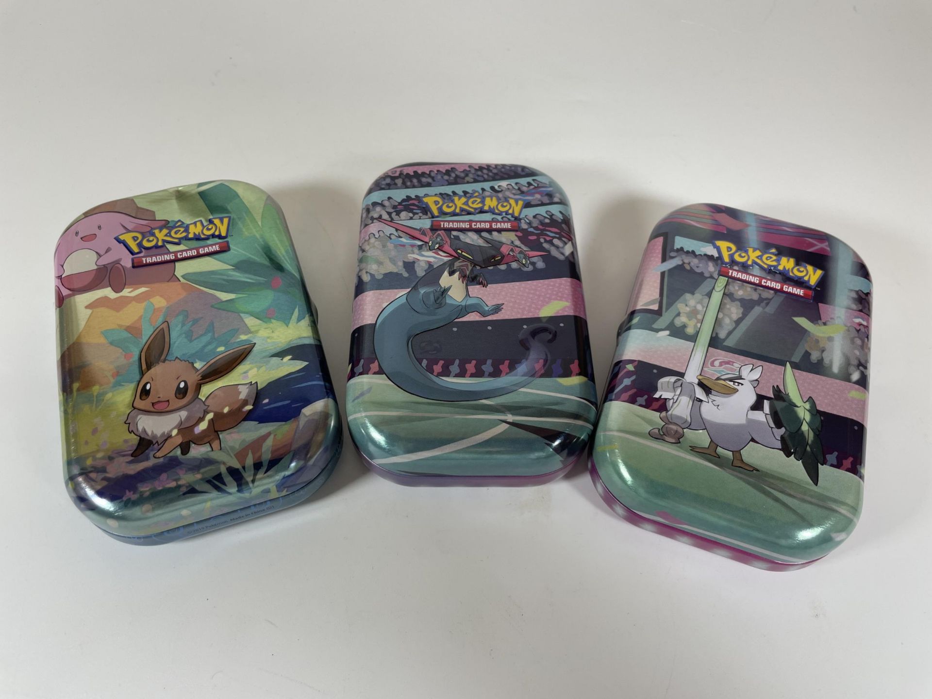 THREE TINS OF ASSORTED POKEMON CARDS, HOLOS SQUIRTLE, MOLTRES ETC - Image 2 of 4